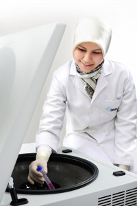 Researcher using Centrifuge in Lab