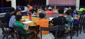 IMU student volunteers tutoring children at Rumah Charis